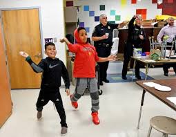 photo of kids throwing items in game with police