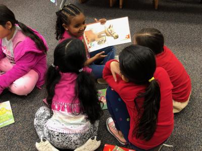 Picture of student reading RIF book